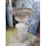 Composition garden urn on stand.