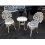 Three piece cast iron garden set with table and two chairs.