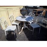 Cast iron garden table with marble top and four garden chairs.