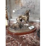 Metal and ceramic model of two dogs with porcelain base signed P J Mene.