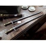 Good pair of 19th. C. French bayonets with original scabbards with matching numbers .
