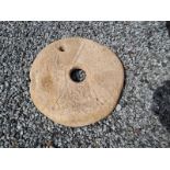 Medieval carved sandstone quern stone.