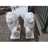 Pair of composition seated lions.