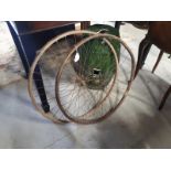 Pair of wooden and metal bicycle wheels. (63 cm H).
