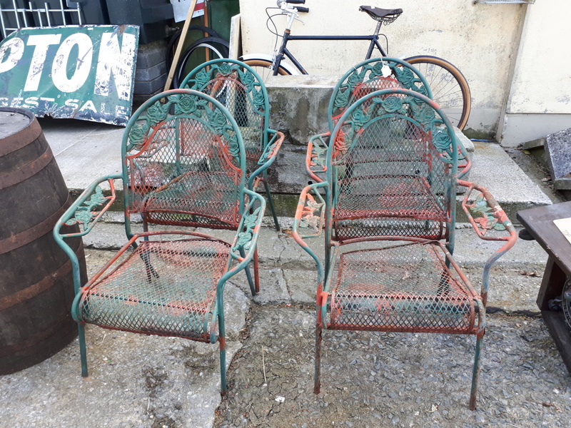 Set of four metal garden chairs.