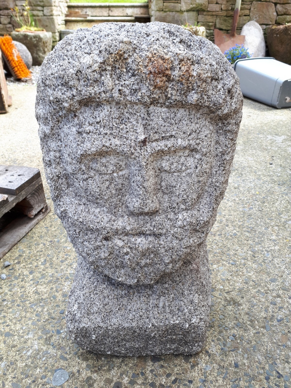 Granite craved figure of a man.