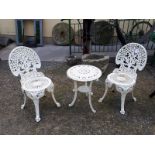 Three piece cast iron garden set with table and two chairs.