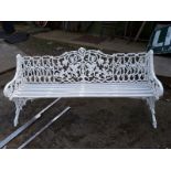 Wrought iron four seat decorative garden bench.