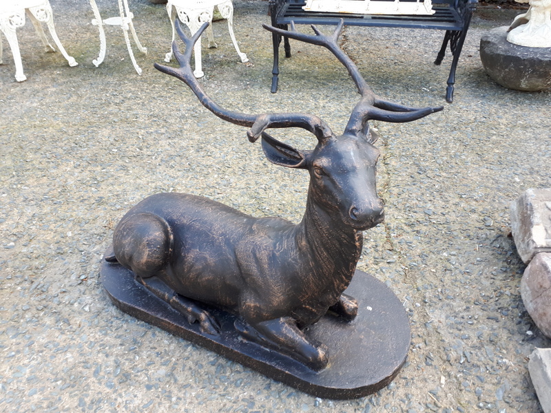 Cast iron model of a stag seated.