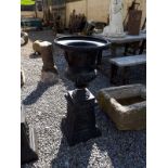 Cast iron urn with base.