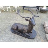 Cast iron model of a stag seated.