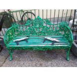 Cast iron three seater metal garden seat with wooden slats decorated with oak leaves.