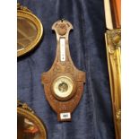 Edwardian carved oak barometer.