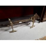 Set of brass fire dogs and irons.