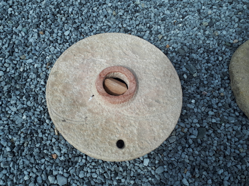 Medieval carved sandstone quern stone.