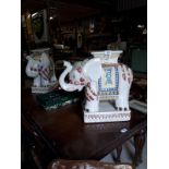 Pair of ceramic plant stands in the form of elephants in the Oriental style.