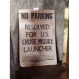 NO PARKING RESERVED FOR US CRUISE MISSILE LAUNCHER paper on card sign.