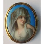 An Oval Cameo Style Brooch, the centre with young lady in period dress.