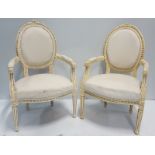 Pair of Cream Continental Armchairs, upholstered and with carved frame.