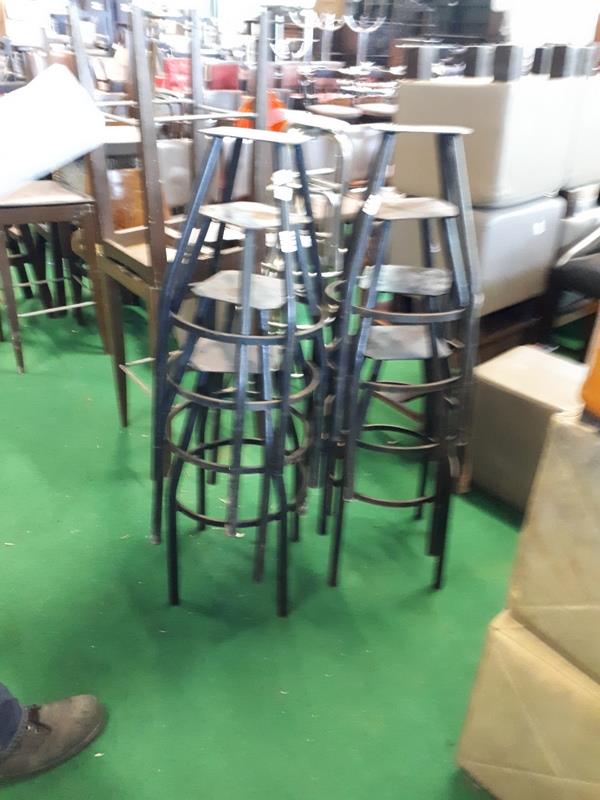 Fifteen metal stool frames.