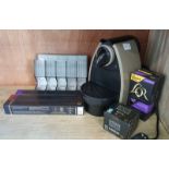 Nespresso Coffee Machine with a selection of capsules & storage rack.