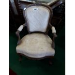 Upholstered carved wooden armchair.