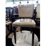 Eight grey leather dining chairs.