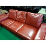 Three seater red leather setee.