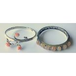 Two Hallmarked Silver Bangles, one set with seven oval coral stones,