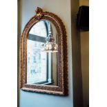 Ornate gilt mirror with arched top. { 82'' H X 55''W }.