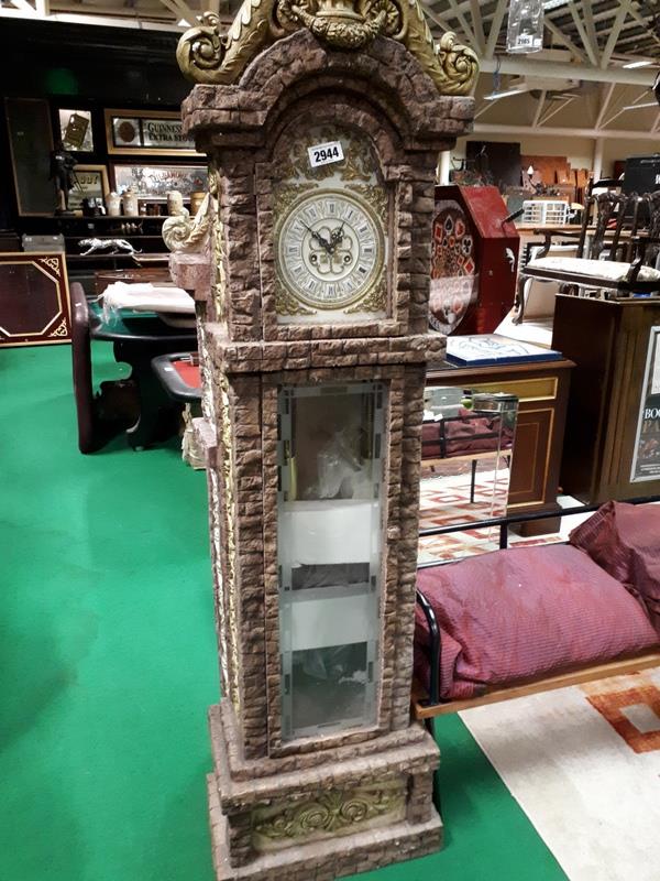 Stone effect grandfather clock.