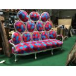 Multicoloured Seat, with silvered frame, 106in (w) x 79in (h).