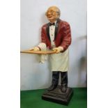 Figure of a Red Jacketed Waiter, with dickie bow, apron and holding a tray. 3ft high.