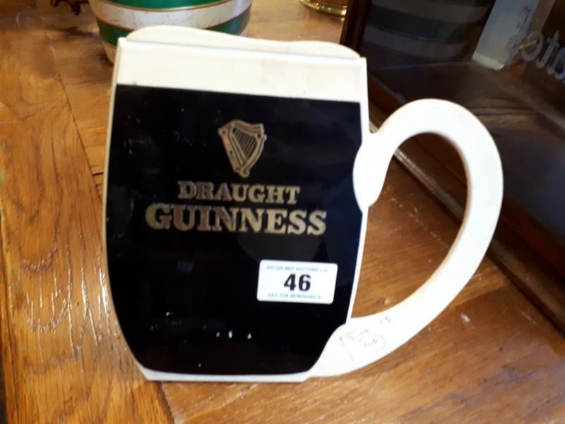 Plastic GUINNESS counter display sign in the form of a pint glass.