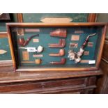 Framed collage of old pipes in display case originally from Cigar Divan, Co Carlow.