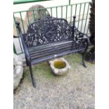 Decorative cast iron two seater garden bench.