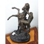 Bronze model of horse and rider mounted on a marble base.