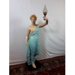 Plaster paris figure of a lady holding a torch aloft electrified.