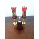 Pair of ruby wine glasses with gilded decoration and a bell.