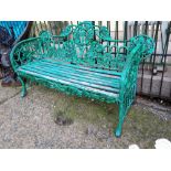 Decorative cast iron garden seat with ivy leaf design and wooden slats.