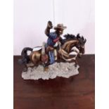 Ceramic figure cowboy on horseback.