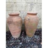 Pair of early 20th C. weathered ribbed terra cotta planters.