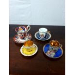 Four decorative porcelain tea cups and saucers.