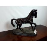 Decorative bronze model of a prancing horse.