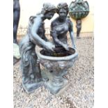 Decorative garden fountain with two ladies pouring water from a ewer into the fountain decorated