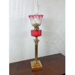 19th. C. oil lamp with brass Corinthian column ruby glass bowl and etched tulip shade.