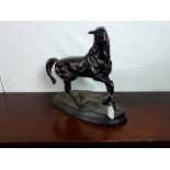 Decorative bronze model of a prancing horse.