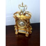 Good quality brass clock with hand painted ceramic panels depicting Japanse scenes.