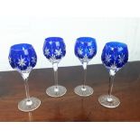 Four cut crystal wine glasses.