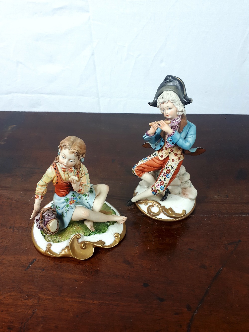 Two decorative porcelain figurines.